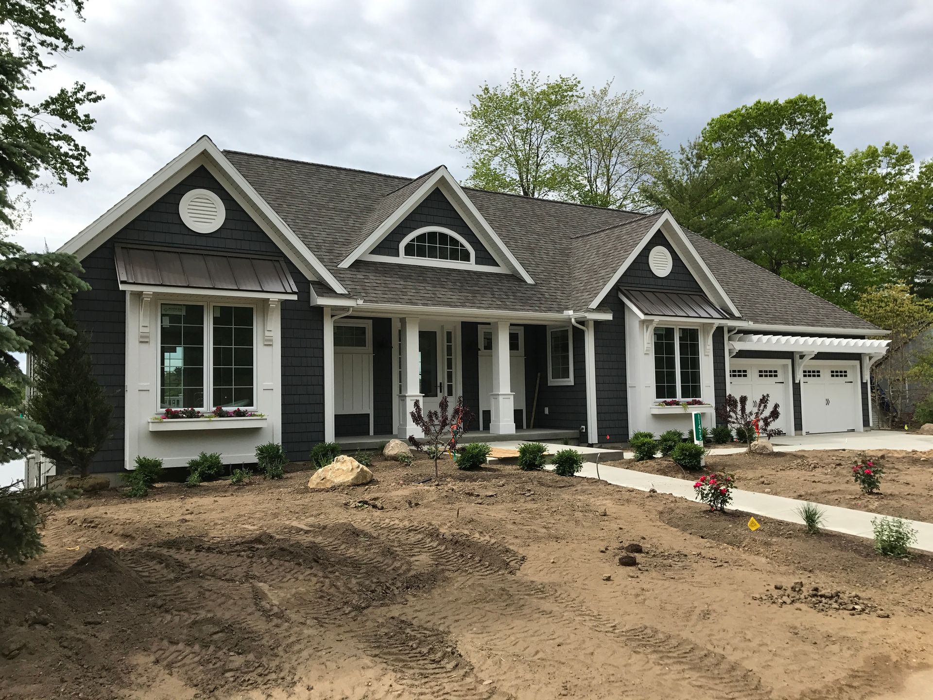 A large black and white house with a gray roof