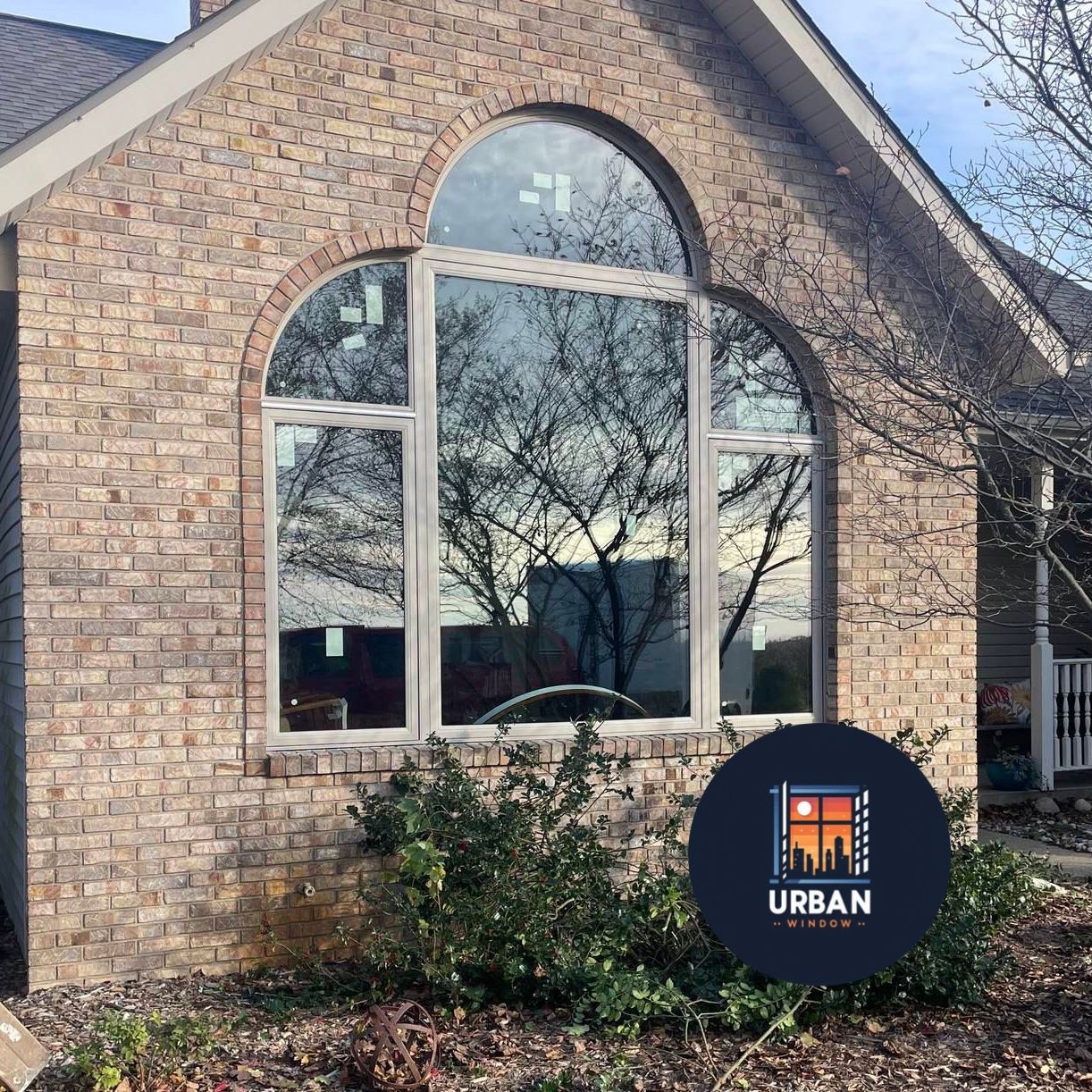A brick house with arched windows and a sign that says urban