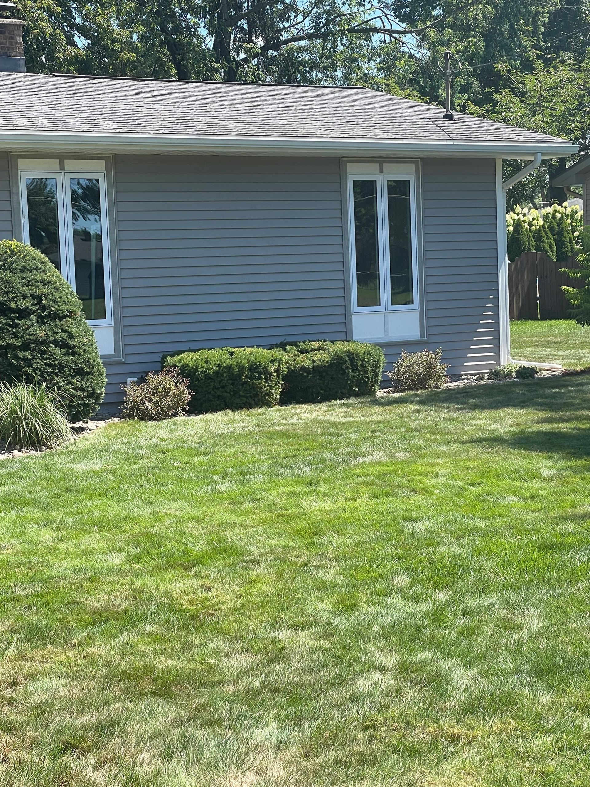 A house with a lush green lawn in front of it