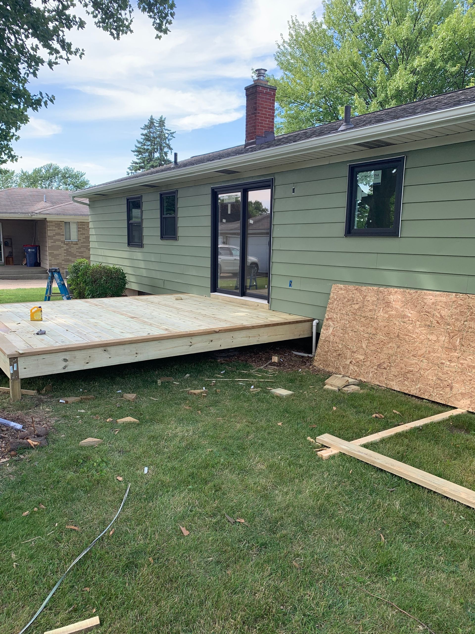 A house with a deck in front of it is being remodeled.