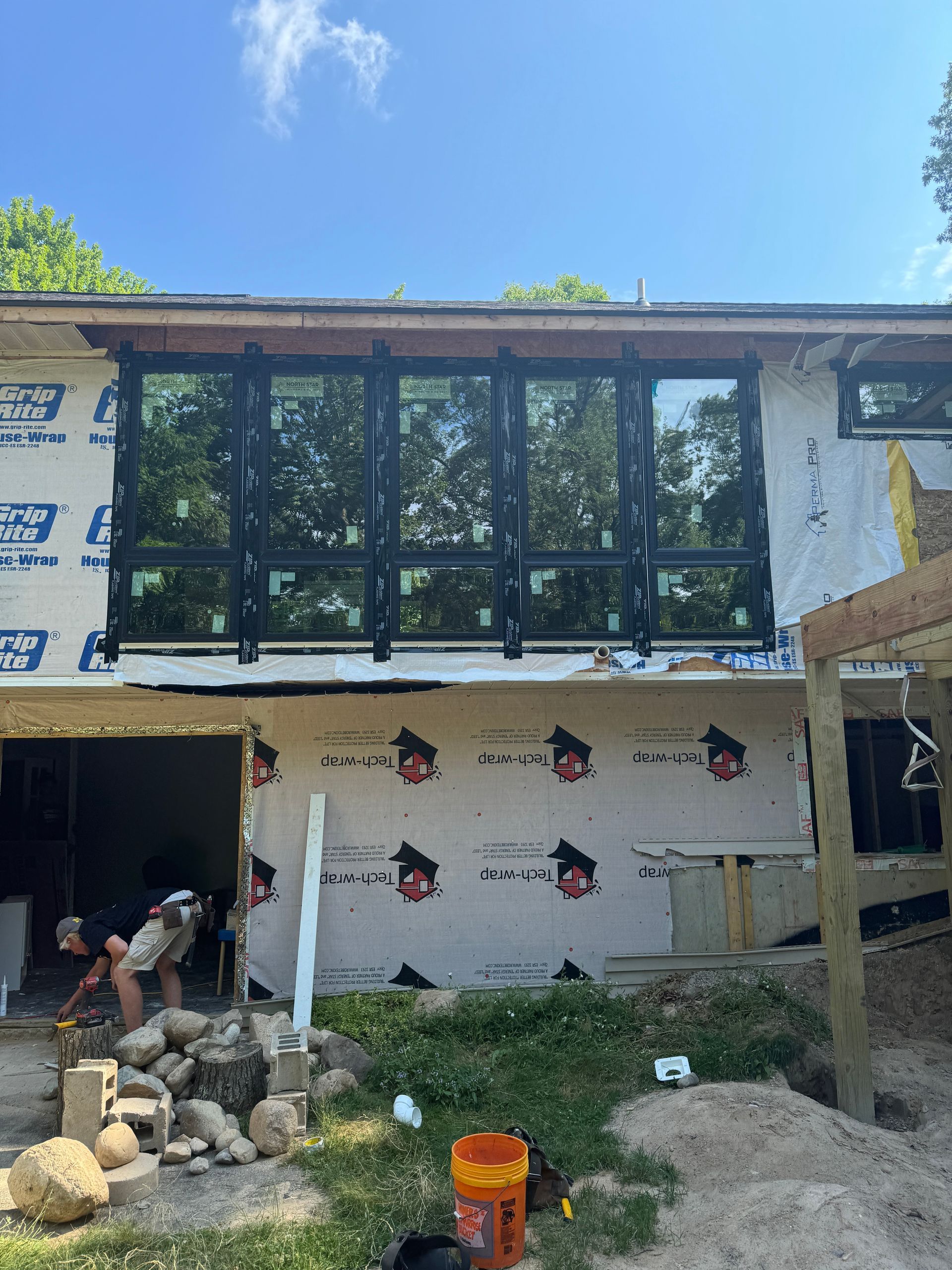 A house is being built with a lot of windows.