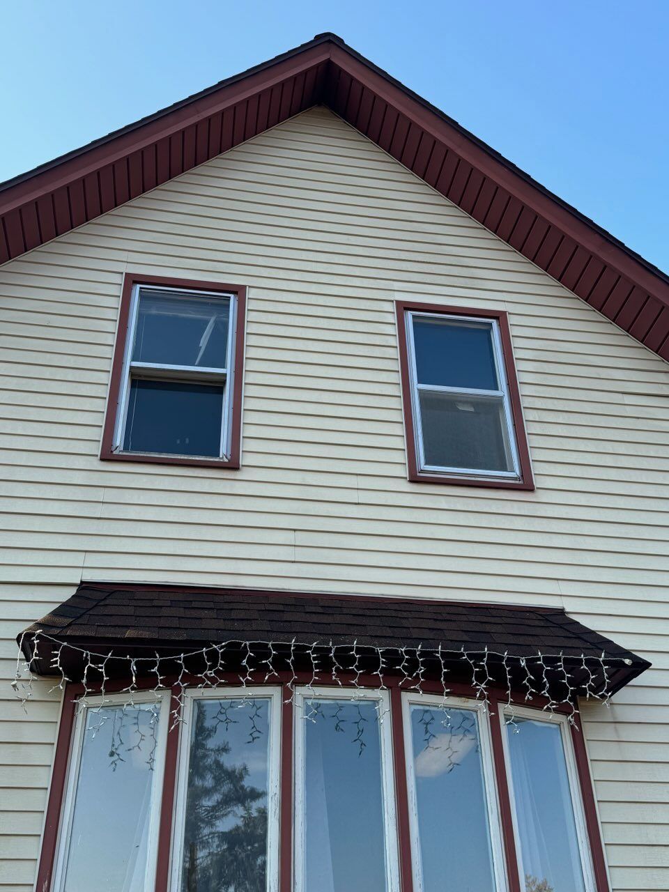 A house with a red roof and a lot of windows