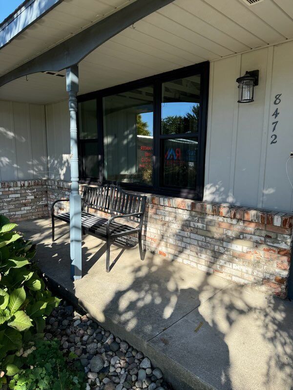 A porch with a bench and a sign that says 5472