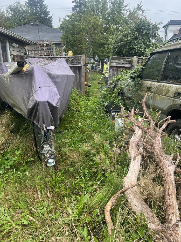 A motorcycle is parked in the grass next to a car.