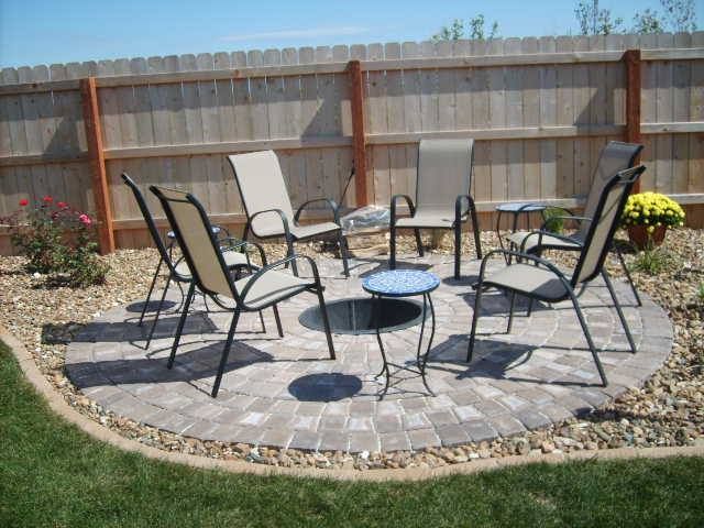 A group of chairs are sitting in a circle on a patio.
