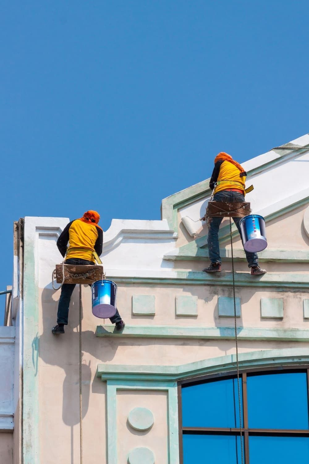 Two Commercial Painters Painting a Wall — Painters in Mackay