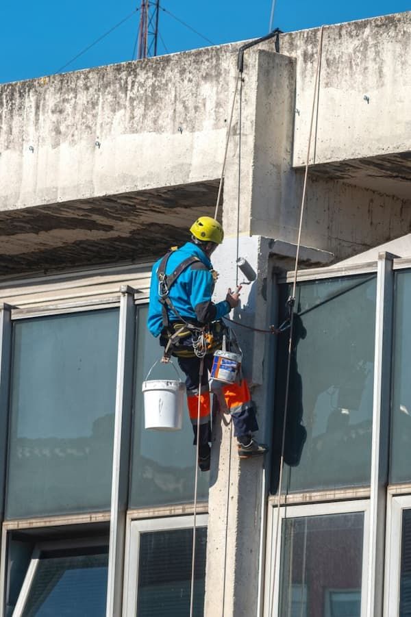 Painter Painting a Wall a On Building — Painters in Mackay