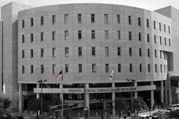 14th Judicial Circuit Court of Florida building with American and Florida flags.