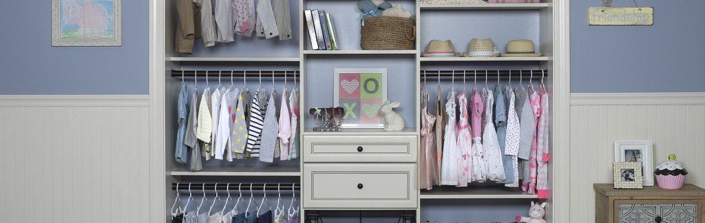 A child 's closet filled with clothes and a drawer.