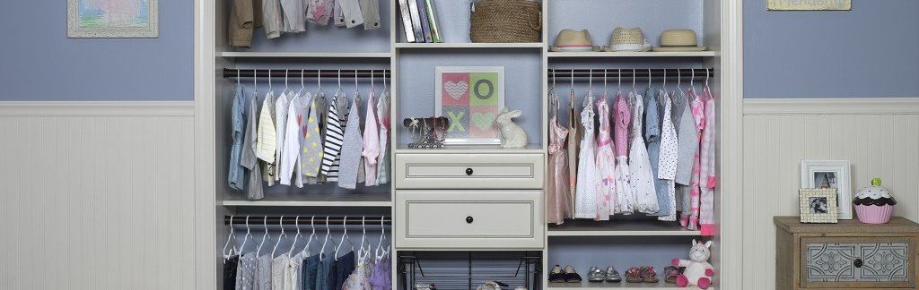 A kids closet filled with lots of clothes and a drawer