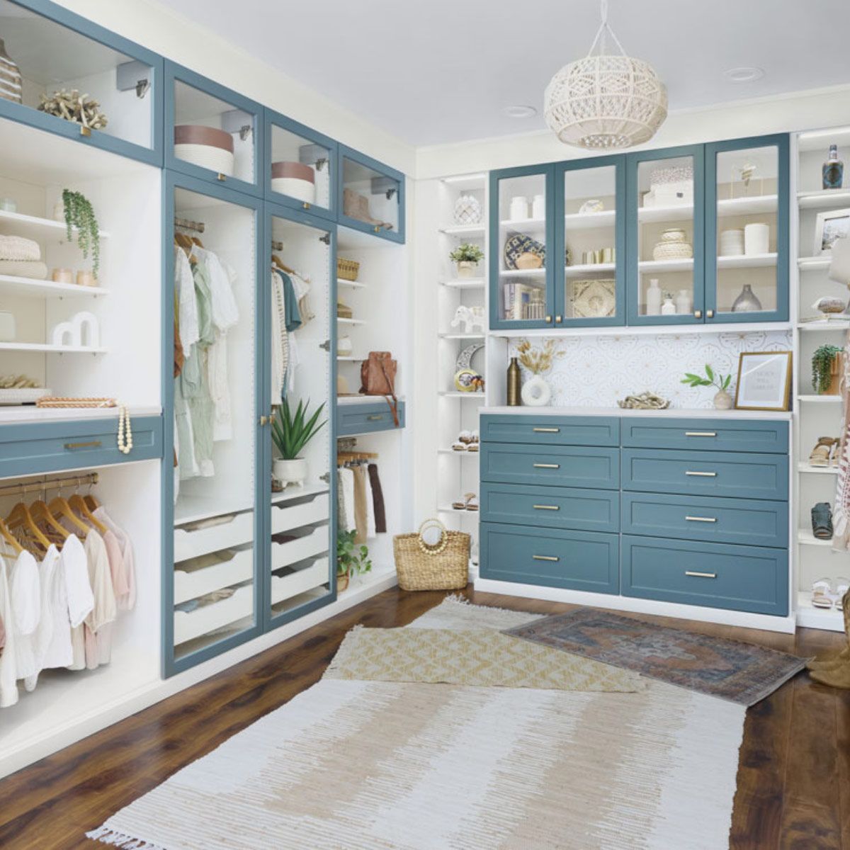 A walk in closet with blue cabinets and drawers