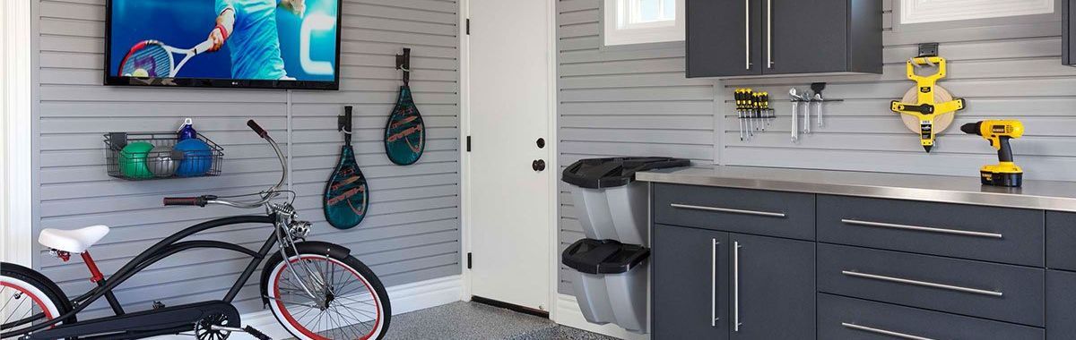 A bicycle is parked in a garage next to a television.