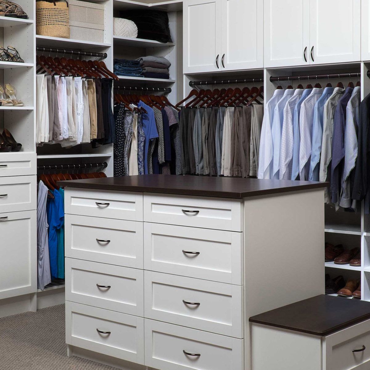 A walk in closet filled with lots of clothes and drawers