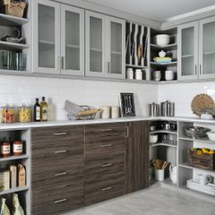 A kitchen with wooden cabinets and glass doors