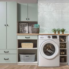 A laundry room with a washer and dryer and a sign that says wash day