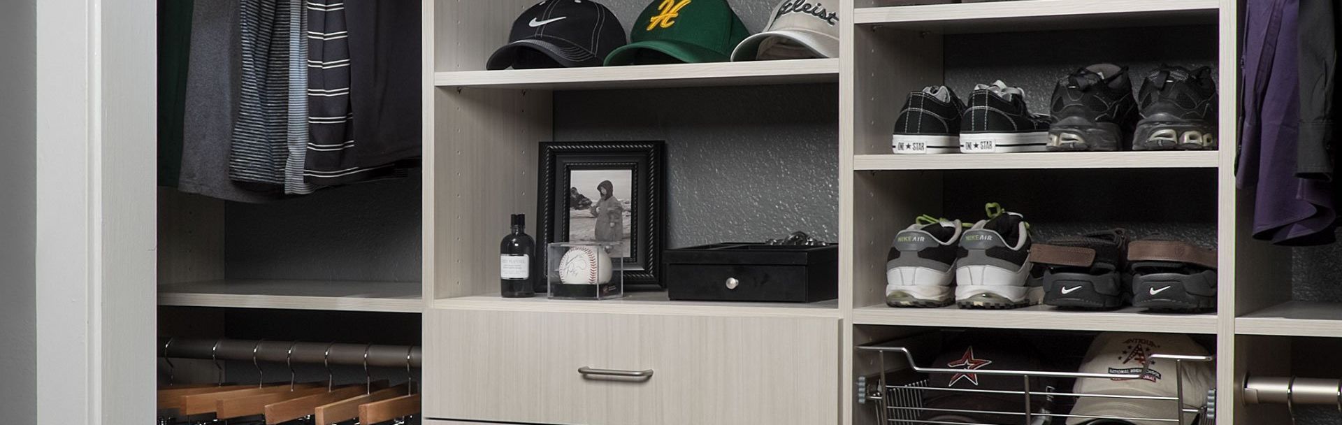 A bed with a blanket and pillows is sitting in a room next to a bookshelf.