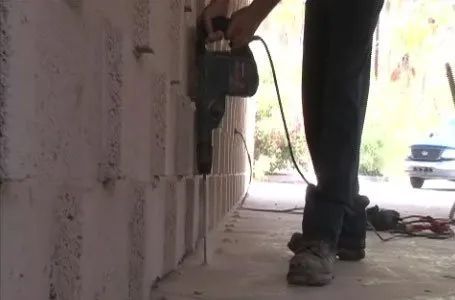 Professional Worker Drilling Holes on the Ground