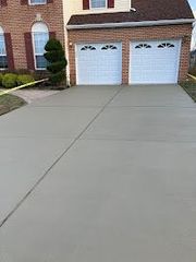 A medusa sign is on the sidewalk in front of a house