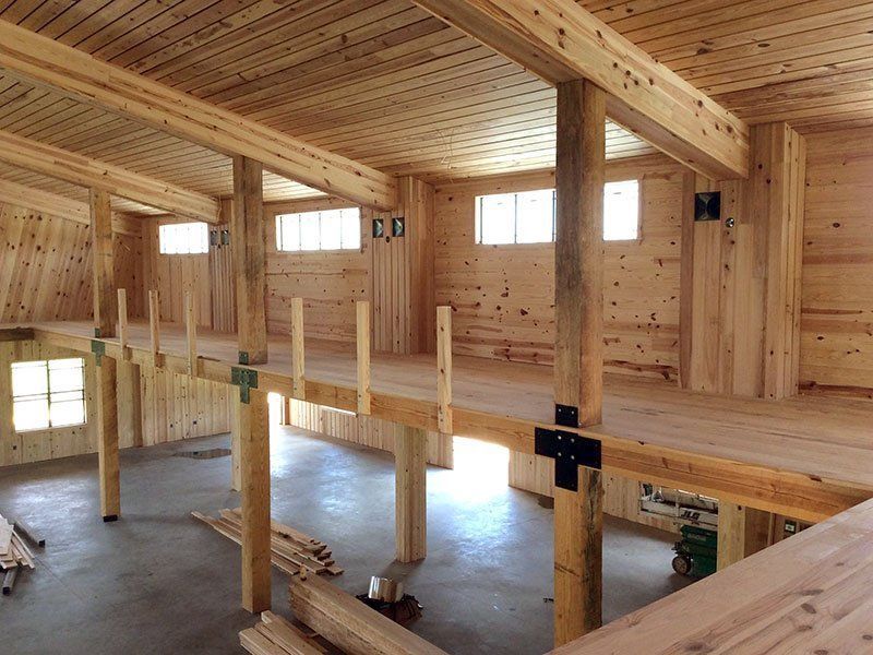 A large room with a wooden floor and ceiling