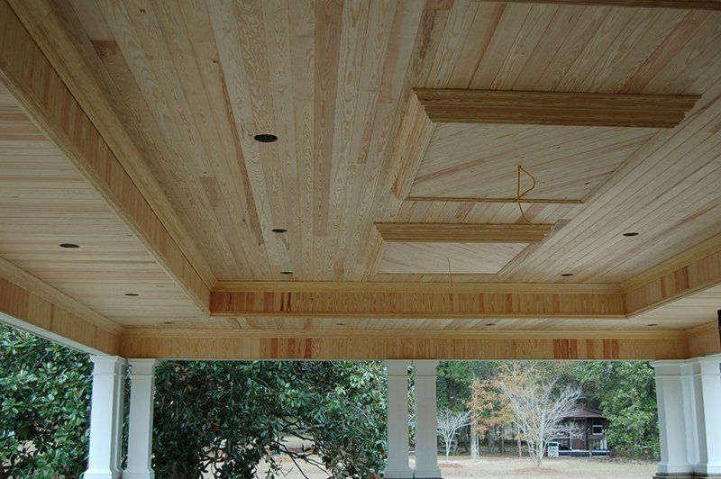A wooden ceiling with a chandelier hanging from it