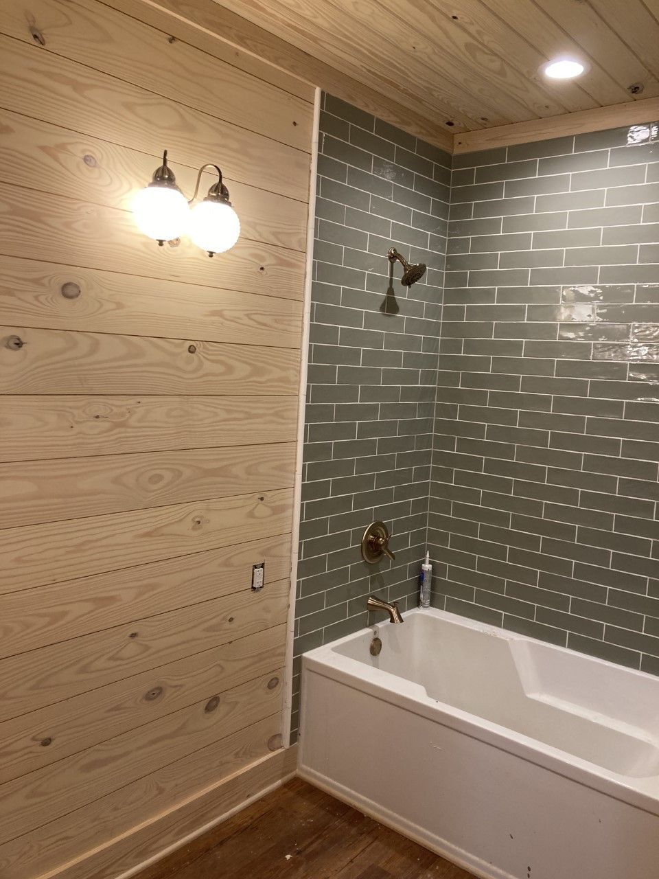 A living room with a couch , chair , coffee table and television.