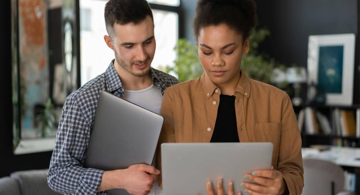 
A man and woman looking at a laptop, deciding whether to make a purchase