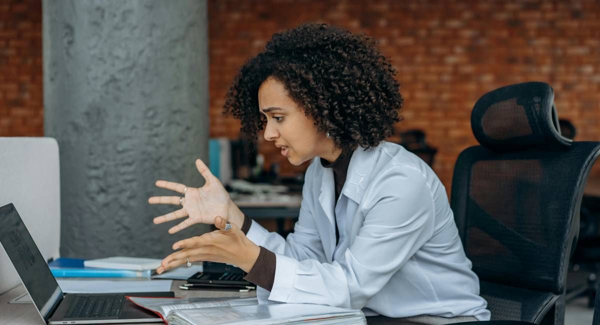 A woman looking at the results of an email campaign on her laptop