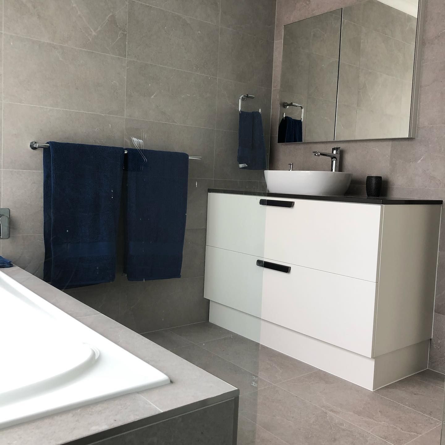 Modern Bathroom With a White Vanity, Vessel Sink, and Gray Tiled Walls — JNR Building And Maintenance in Green Hill, QLD