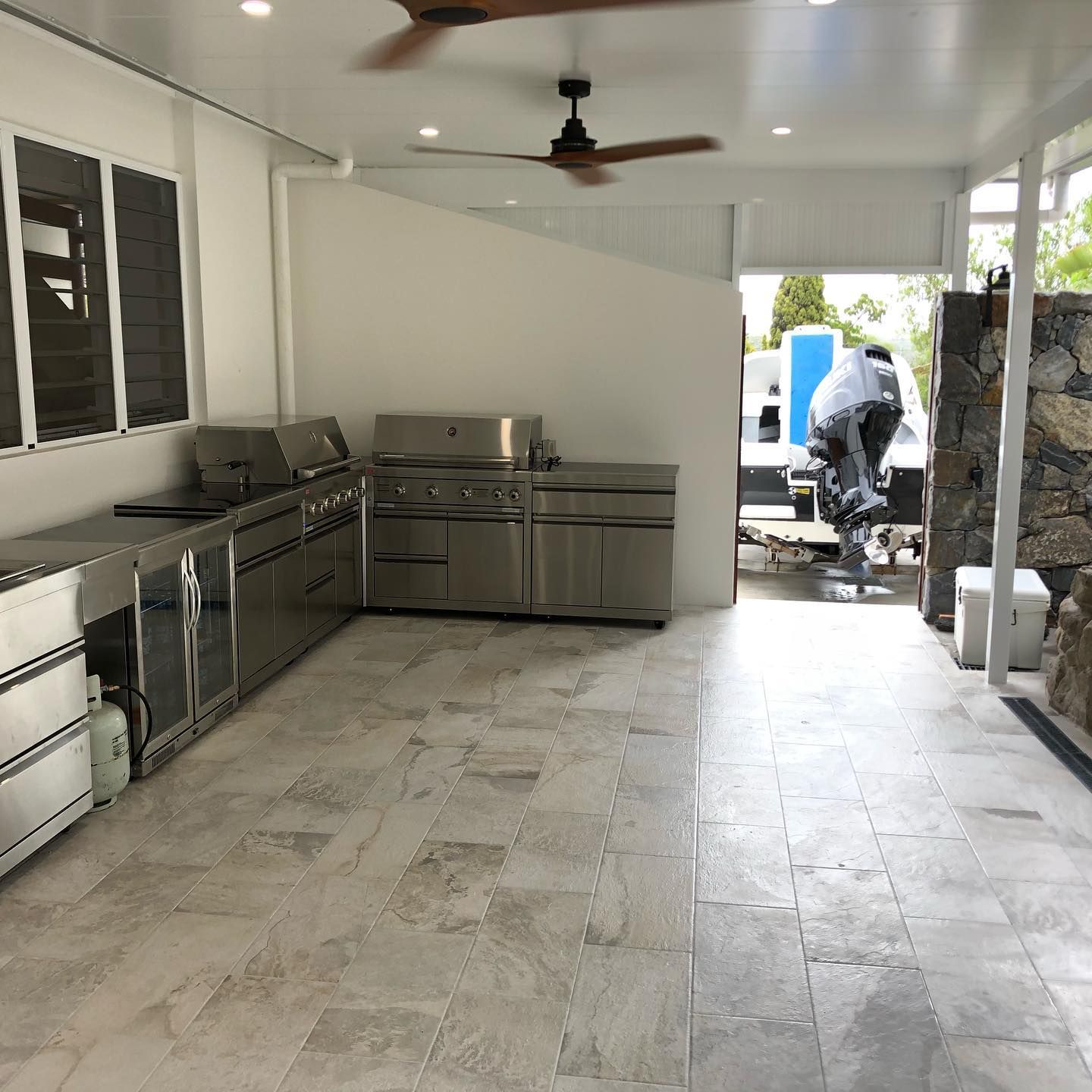 Outdoor Kitchen With Stainless Steel Appliances and Stone Tile Flooring — JNR Building And Maintenance in Green Hill, QLD