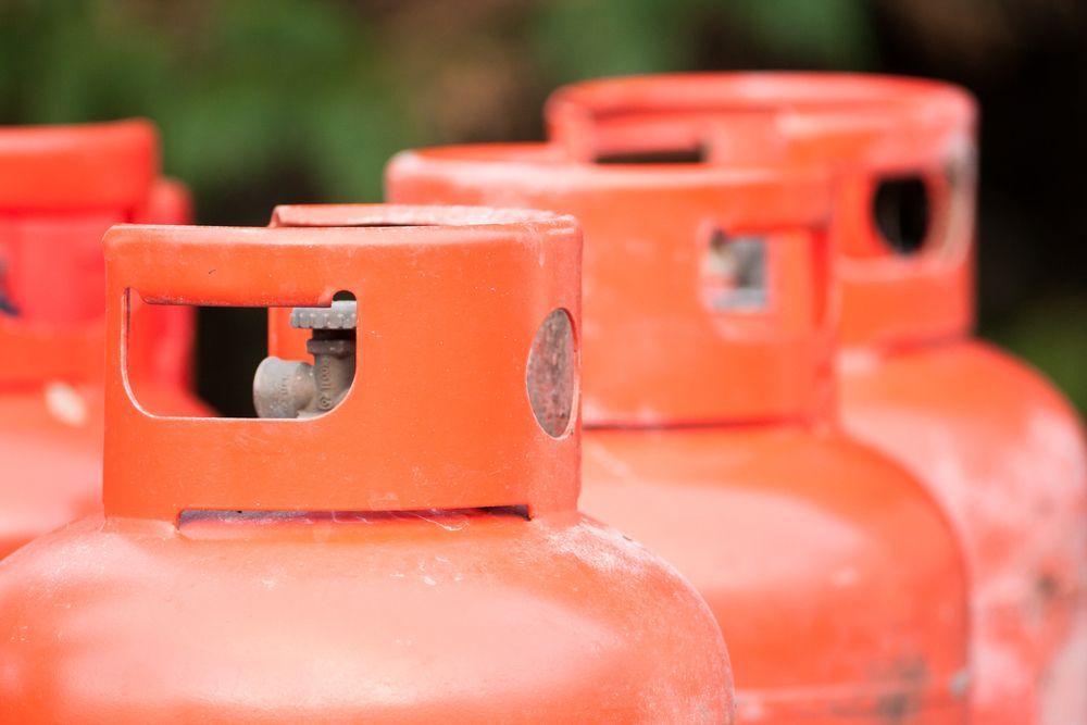 A Row of Orange Gas Cylinders Sitting Next to Each Other — Bundy Ice in Bundaberg East, QLD