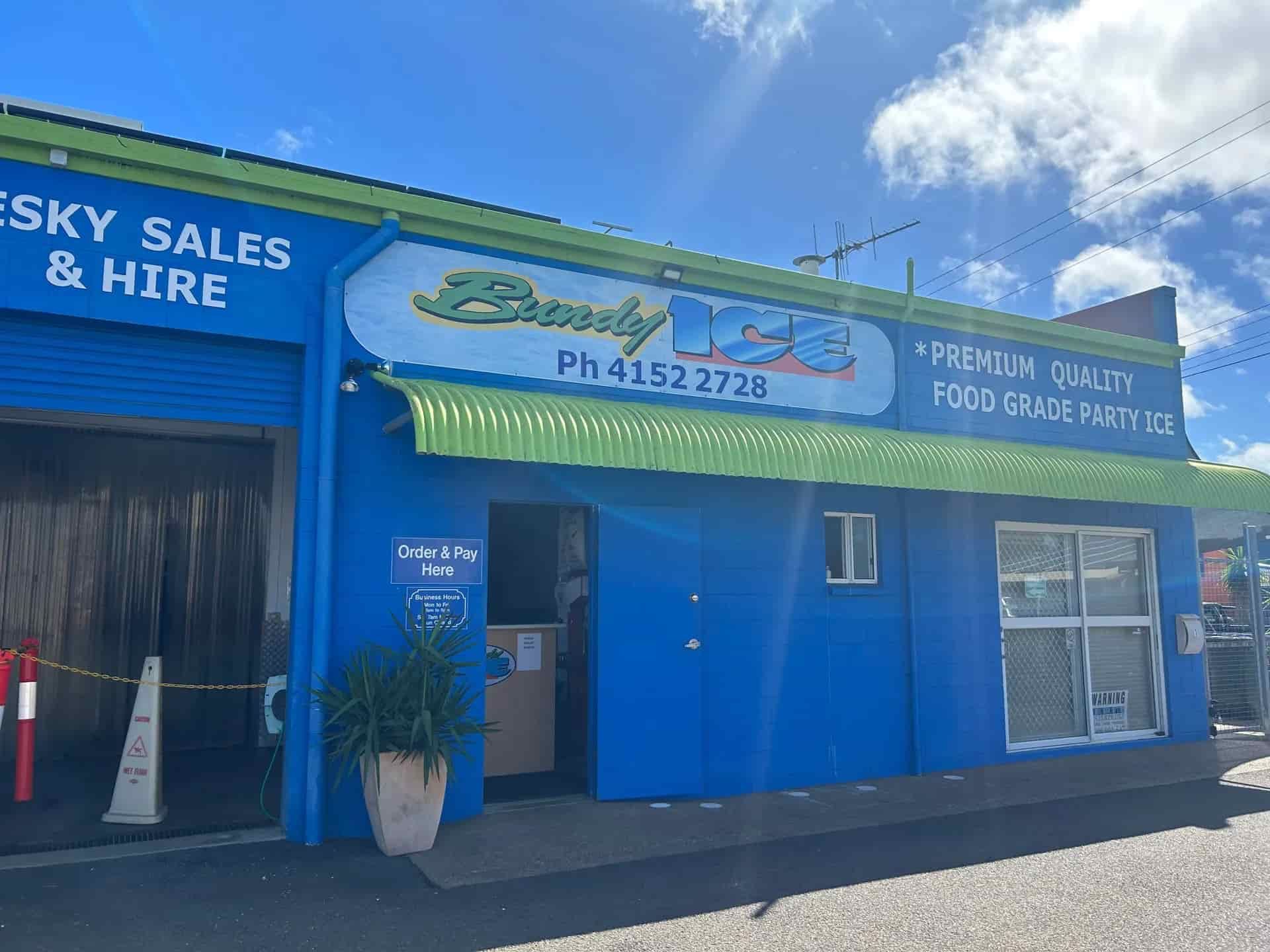 A Blue Building With a Green Awning and a Sign That Says Bundy Ice & Hire — Bundy Ice in Bundaberg East, QLD