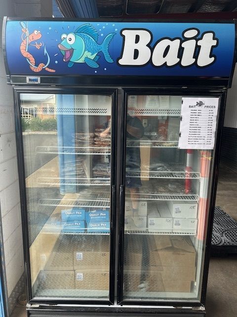 A Plastic Bag Filled With Fishing Bait is Sitting on the Ground — Bundy Ice in Bundaberg East, QLD