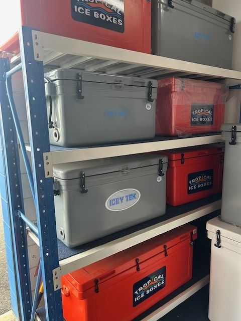 Two Coolers Filled With Ice Are Sitting on the Ground — Bundy Ice in Bundaberg East, QLD