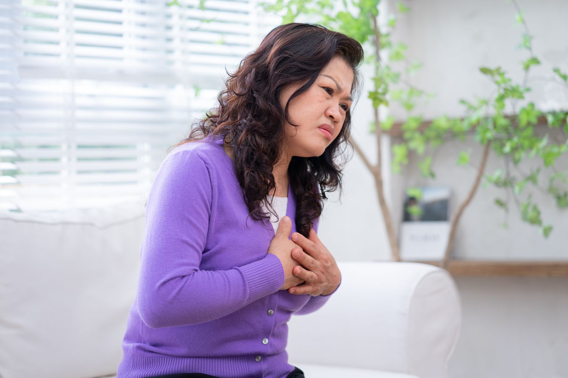 a woman experiencing chest pain