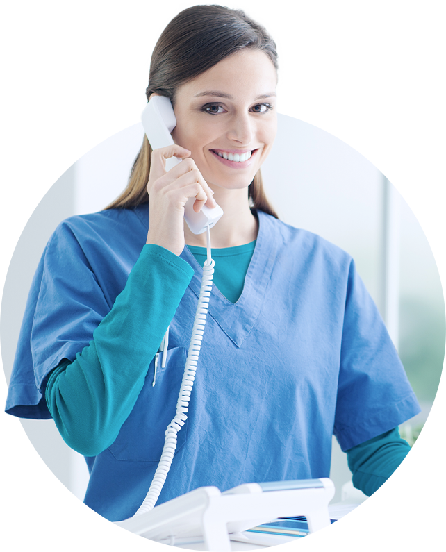 a woman in a blue scrub is talking on a phone