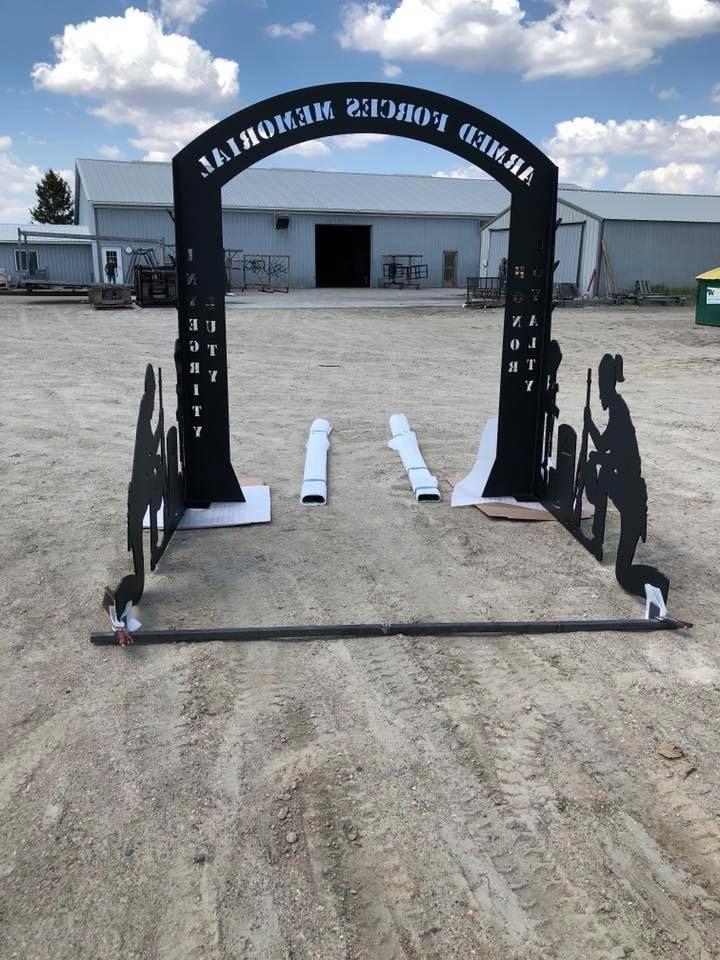 a metal archway with the word memorial on it