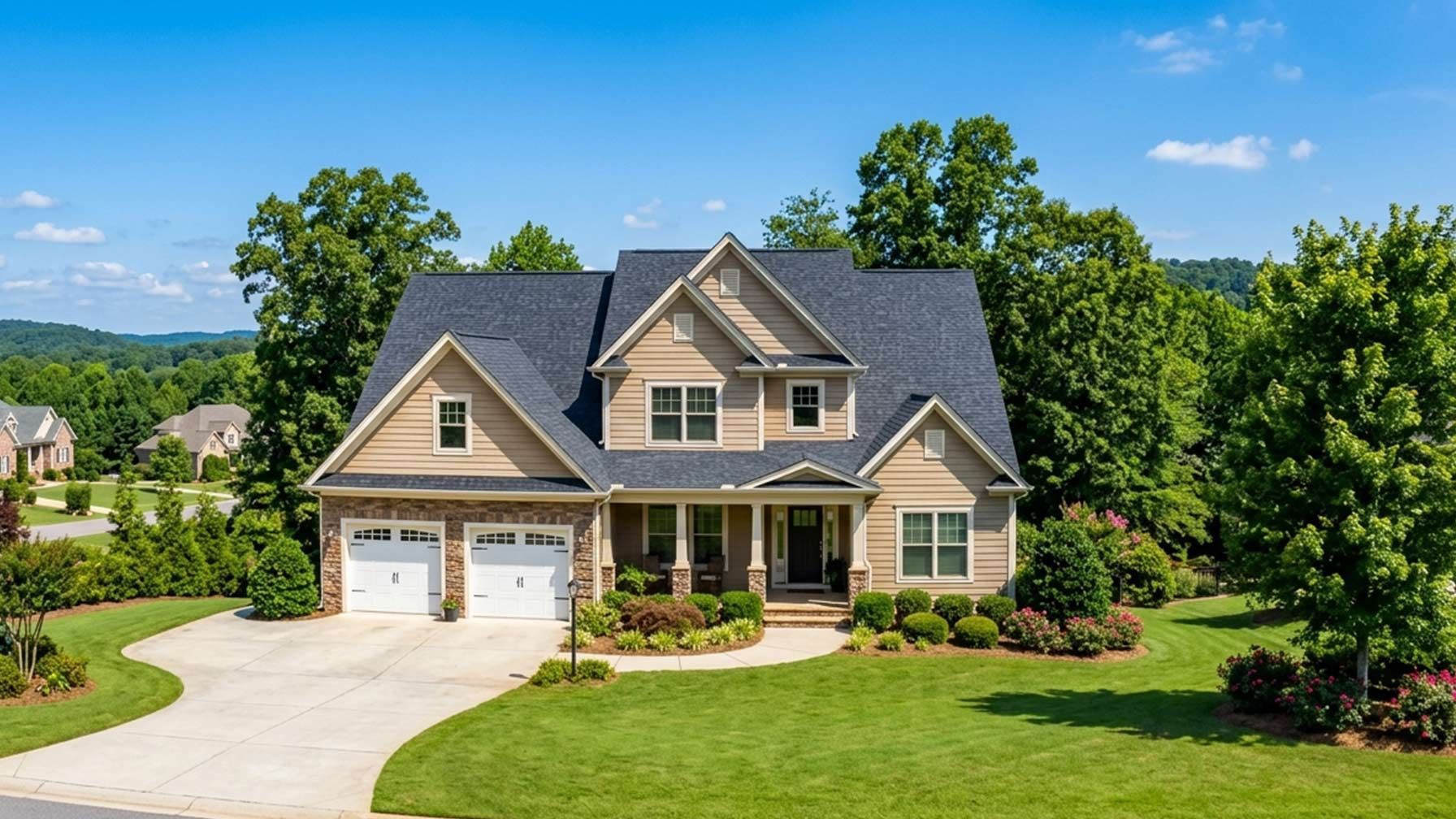 A professional photo of a beautiful suburban home in Upstate South Carolina, showcasing a well-maintained asphalt shingle roof under a clear blue sky with local Greenville-area greenery.