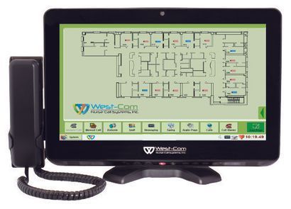 A West-Com touchscreen console showing a building layout, with a telephone handset attached.