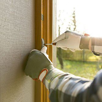 Handyman fixing the window with screwdriver