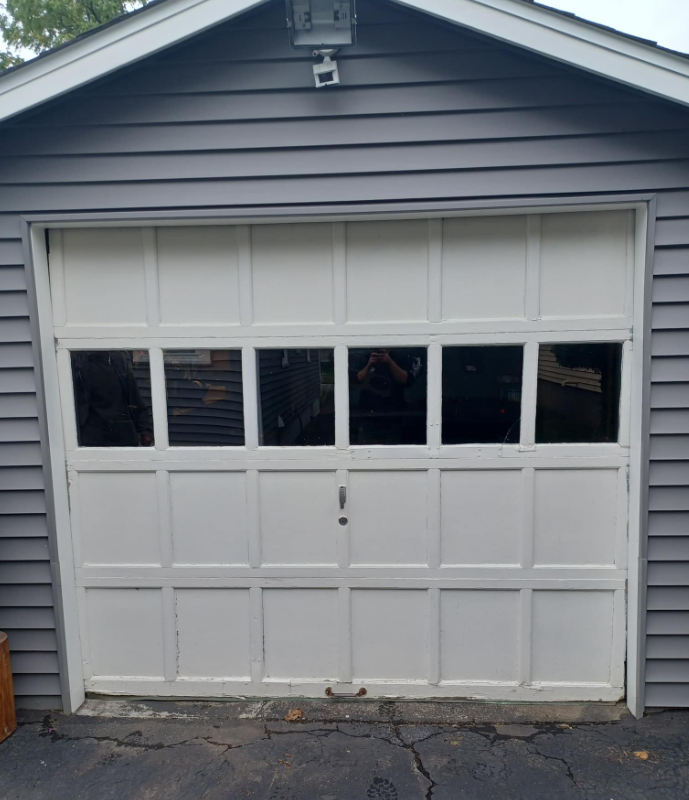 wooden garage door with peeling and chipped paint