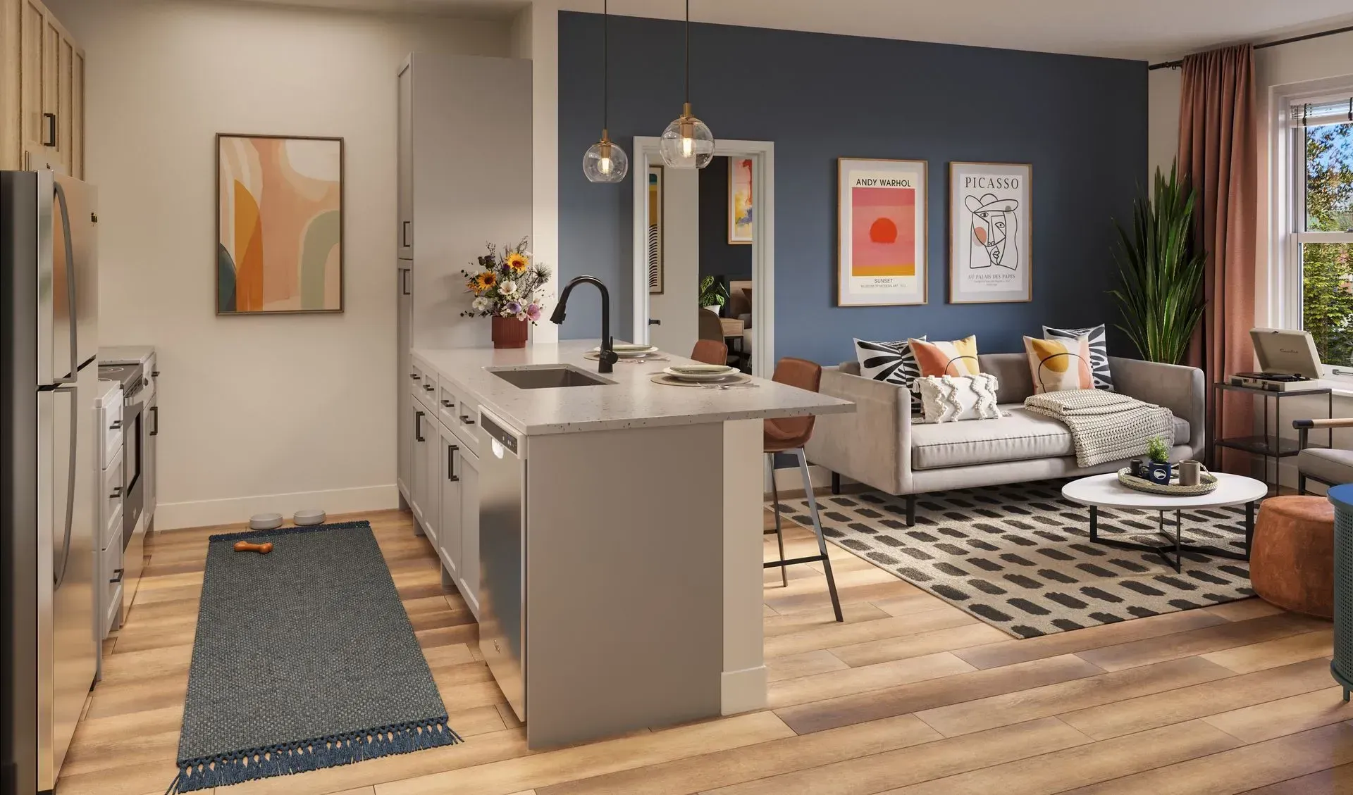 Open-concept apartment interior with a kitchen island, stainless appliances, and a blue-accented living area.