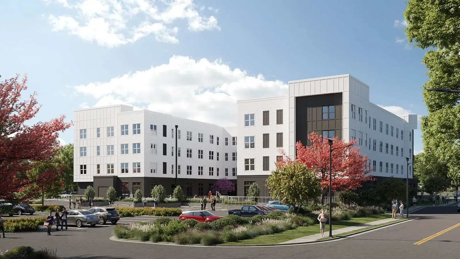 Exterior view of a modern white apartment building with landscaped grounds, trees, and a circular drive.