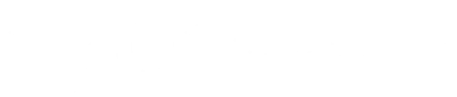 A close-up of a small, bright yellow, multi-petaled flower with a fuzzy, textured center in bloom.