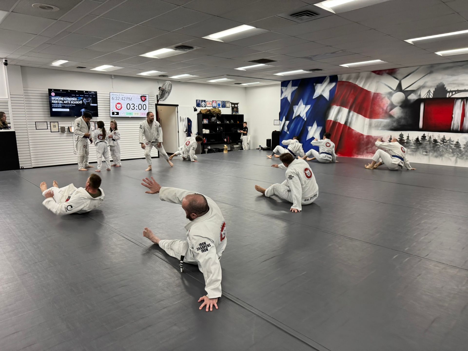 Adults drilling grappling techniques at Grit Jiu-Jitsu & Muay Thai Martial Arts in Spokane Valley.