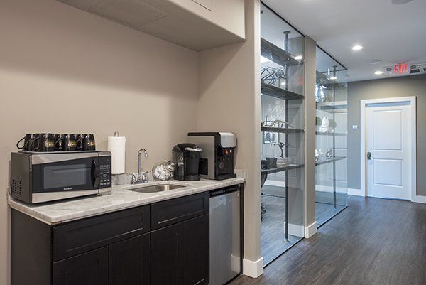 Common area kitchenette with coffee and filtered waters for members to share