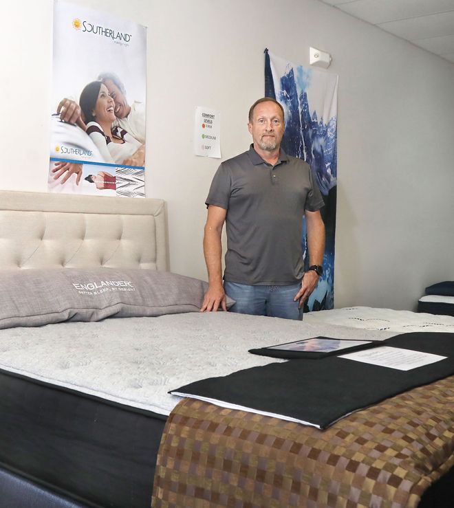 Owner and Veteran Justin in His showroom at Derby Mattress