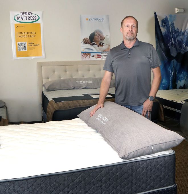 Owner and Veteran Justin in His showroom at Derby Mattress