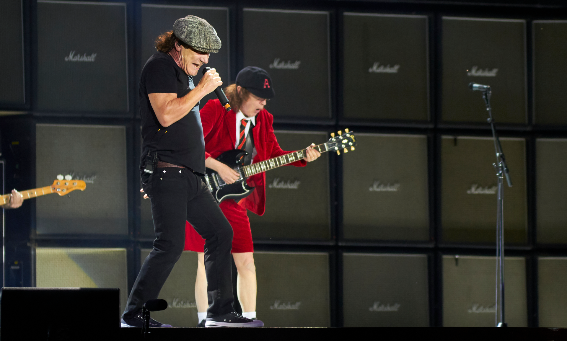 AC/DC performing live at Wembley Stadium, electrifying the crowd with their legendary hard rock music.