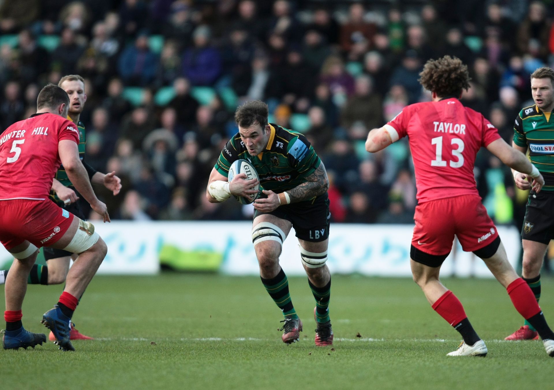 A group of rugby players are playing a game on a field.