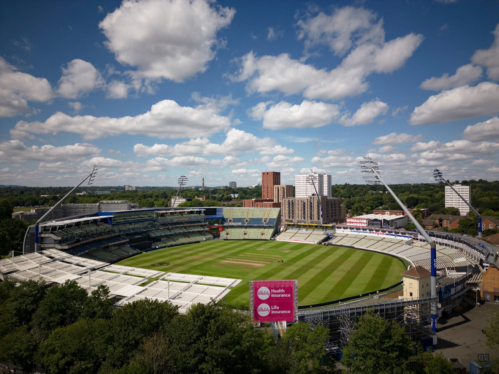 An aerial view of a cricket stadium on a sunny day